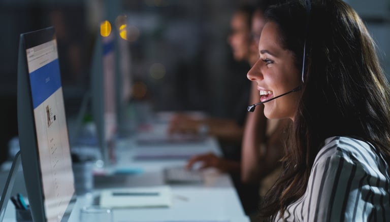 Attractive young female call center agent working in the office
