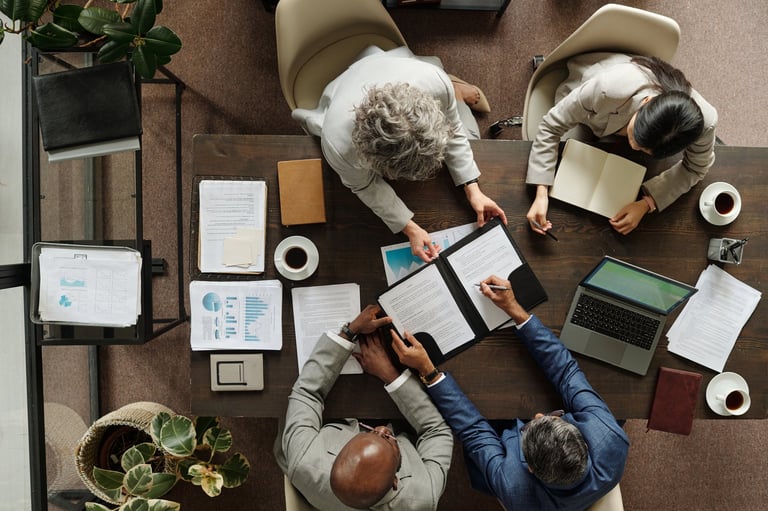 Group of multiethnic business professionals collaborating around table